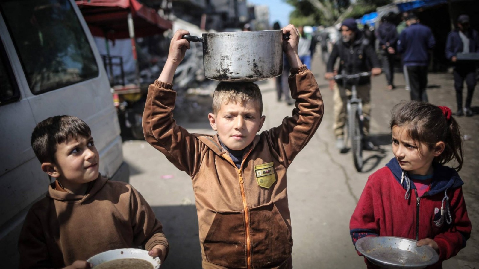 أطفال يتجهون نحو نقطة توزيع مساعدات غذائية في خان يونس بجنوب قطاع غزة 