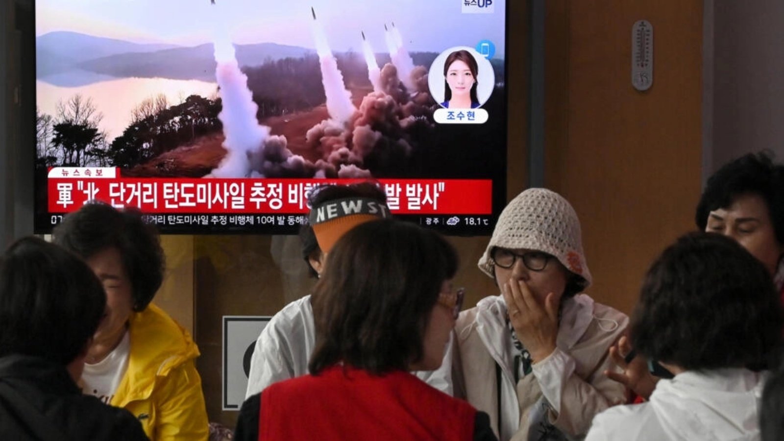 أشخاص أمام شاشة التلفزيون في سيول بتاريخ 30 أيار/مايو 2024 حيث يظهر بث إخباري لاختبار صاروخي كوري شمالي 