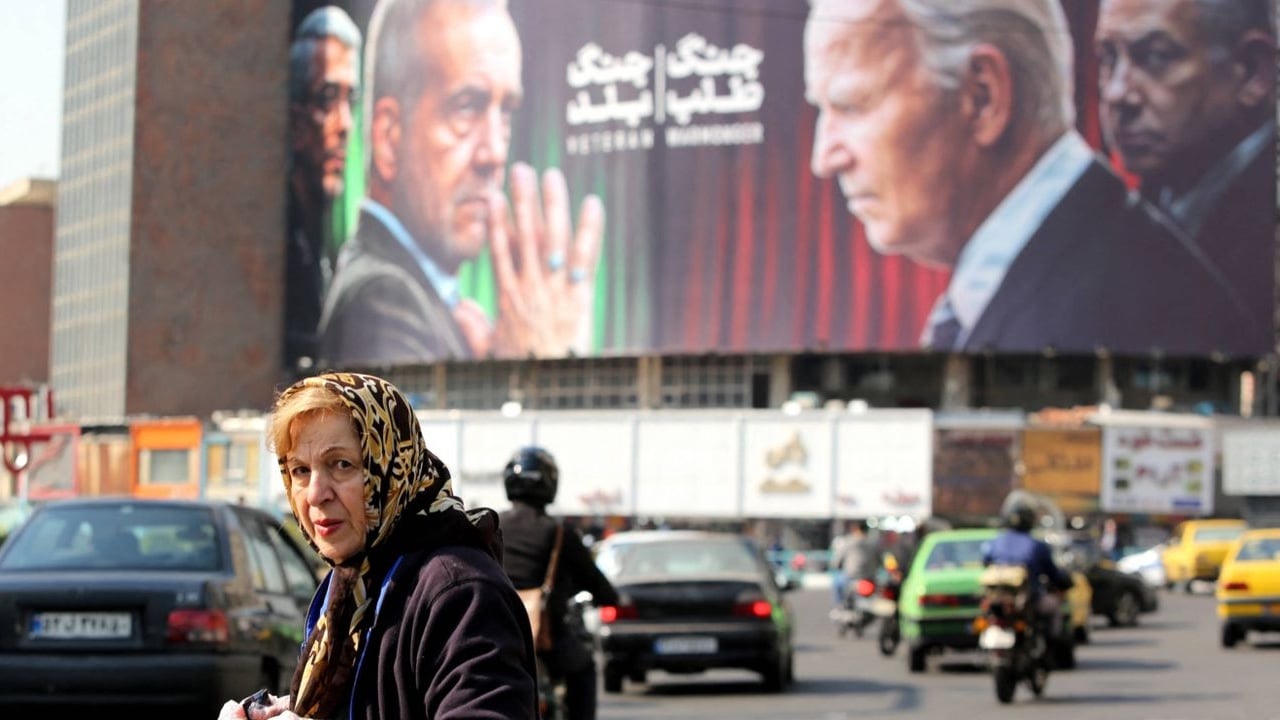 لوحة إعلانية تظهر الرئيس الإيراني مسعود بزشكيان، ورئيس أركان القوات المسلحة محمد باقري، والرئيس الأمريكي جو بايدن، ورئيس الوزراء الإسرائيلي بنيامين نتنياهو في ساحة ولي عصر بطهران في 27 أكتوبر 2024 