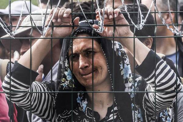 لاجئة سورية أمام سياج عند حدود المجر