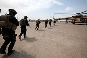 فصيل عراقي يهدد باستهداف القوات الأميركية