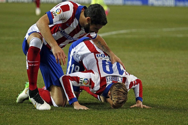  النجم الاسباني فرناندو توريس مهاجم أتلتيكو مدريد يقبل أرضية ملعب فيسينتي كالديرون