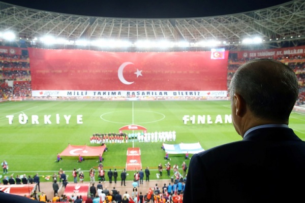 صورة ملتقطة في 24 مارس 2017 للرئيس التركي إردوغان يستمع وقوفا للنشيدين الوطنيين، قبيل مباراة بين منتخب بلاده وفنلندا