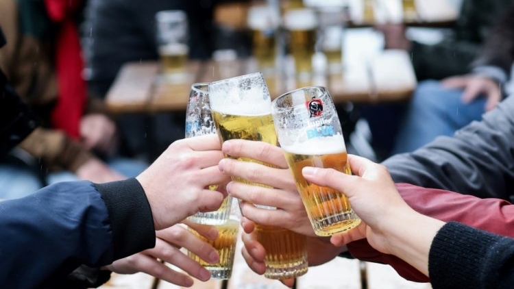 أصدقاء يتناولون البيرة معا على شرفة مقهى في بروكسل في 8 أيار/مايو 2021 بعدما قررت الحكومة البلجيكية تليين القيود المفروضة لمكافحة وباء كوفيد-19