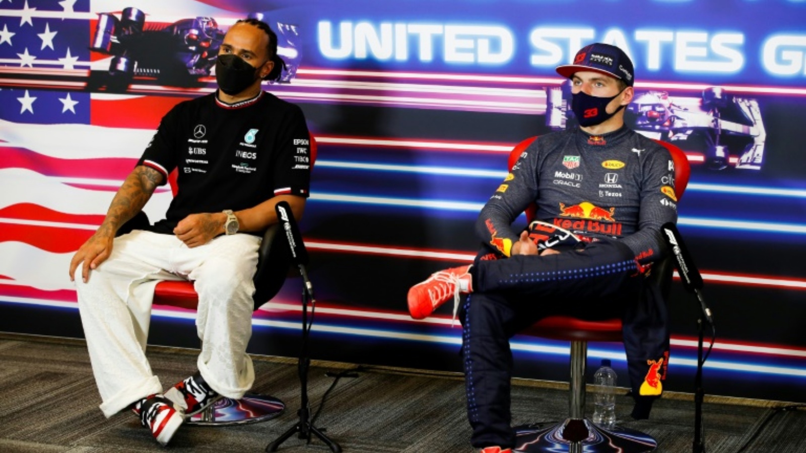 سائق مرسيدس البريطاني لويس هاميلتون (يسار) يجلس إلى جانب سائق ريد بول الهولندي ماكس فيرستابن خلال مؤتمر صحافي عشية جائزة الولايات المتحدة لسباقات فورمولا واحد. 24 تشرين الأول/أكتوبر 2021.
