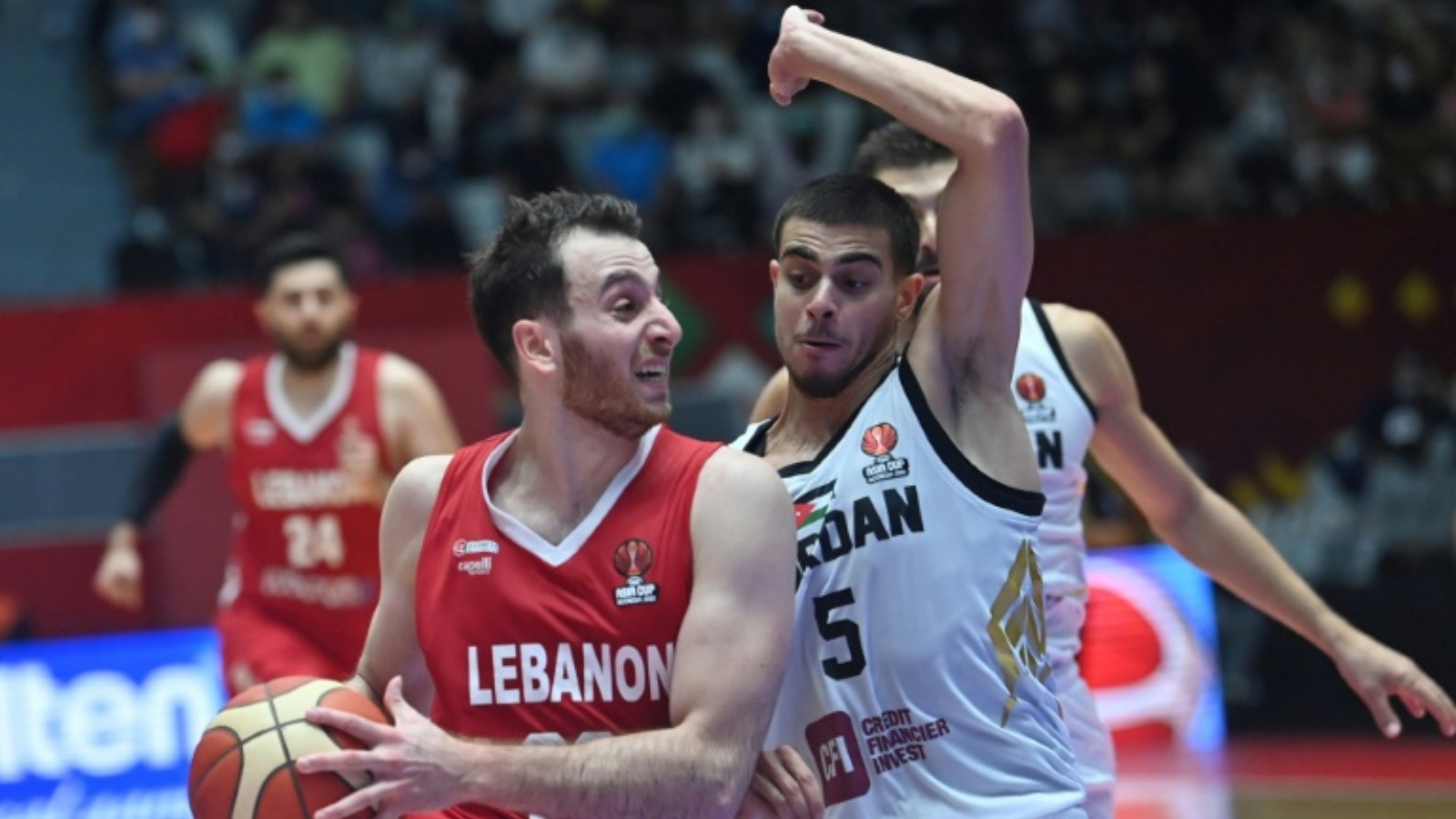 اللبناني وائل عرقجي (يسار) خلال محاولة الاختراق أمام الأردني فريدي إبراهيم (يمين) في مباراة نصف نهائي كأس آسيا لكرة السلة. جاكرتا في 23 يوليو 2022