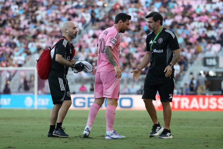 Lionel Messi, center, walks off after suffering a minor right leg muscle injury that will keep him out of Inter Miami's crucial Leagues Cup match against Pumas