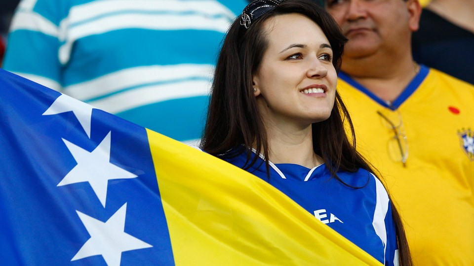 Bosnia soccer team supporters dance in the stadium before the group F World Cup soccer match between Nigeria and Bosnia at the Arena Pantanal in Cuiaba, Brazil, Saturday, June 21, 2014