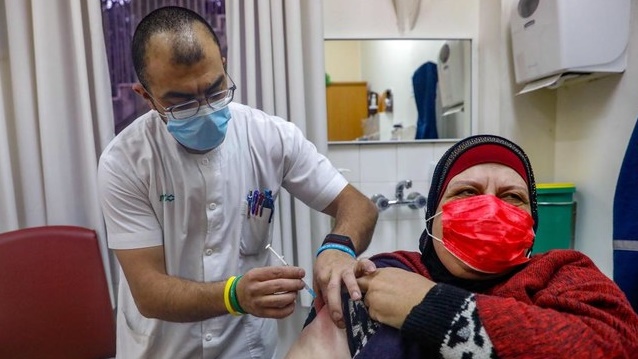 سيدة فلسطينية تتلقى اللقاح