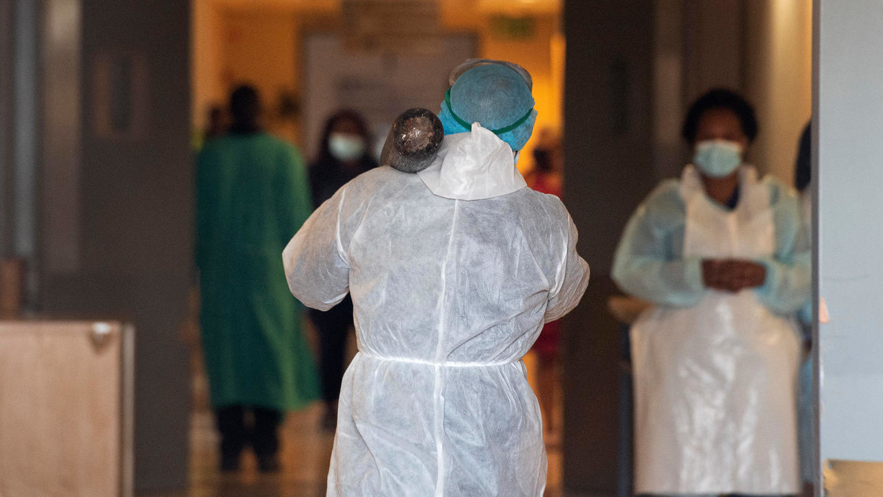 ممرض جنوب إفريقي يحمل قارورة أكسيجين في مستشفى كاييليتشا في جنوب إفريقيا في 29 كانون الأول/ديسمبر 2020