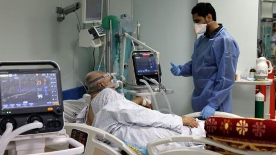  المصاب الفلسطيني بفيروس كورونا حسين الحاج (71 عاما) يتحدث إلى الممرض في غرفة العناية المكثفة في مستشفى الصداقة الفلسطيني التركي في 22 أبريل 2021