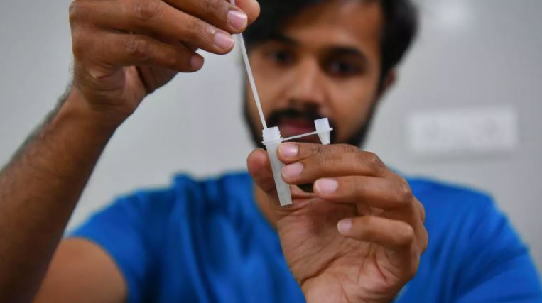 طبيب يعرض كيفية استخدام الاختبار المنزلي للكشف عن كوفيد، في مختبر مايلاب في لونافلا على بعد 90 كلم شرق بومباي، في 10 حزيران/يونيو 2021
