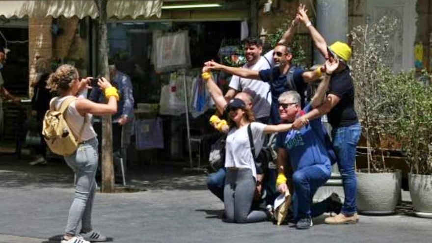  مجموعة تتجهز لالتقاط صورة في شارع في القدس في 18 أبريل 2021