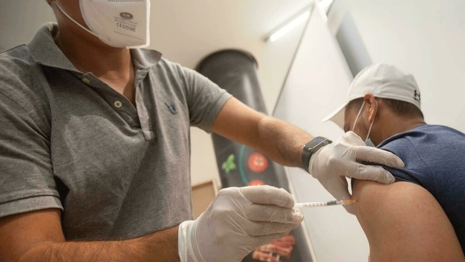 رجل يحصل على حقنة Covid-19 في محطة التطعيم في فيينا في 25 أغسطس 2021 ؛ اعتبارًا من فبراير 2022 ، ستكون اللقاحات ضد الفيروس إلزامية للبالغين في النمسا