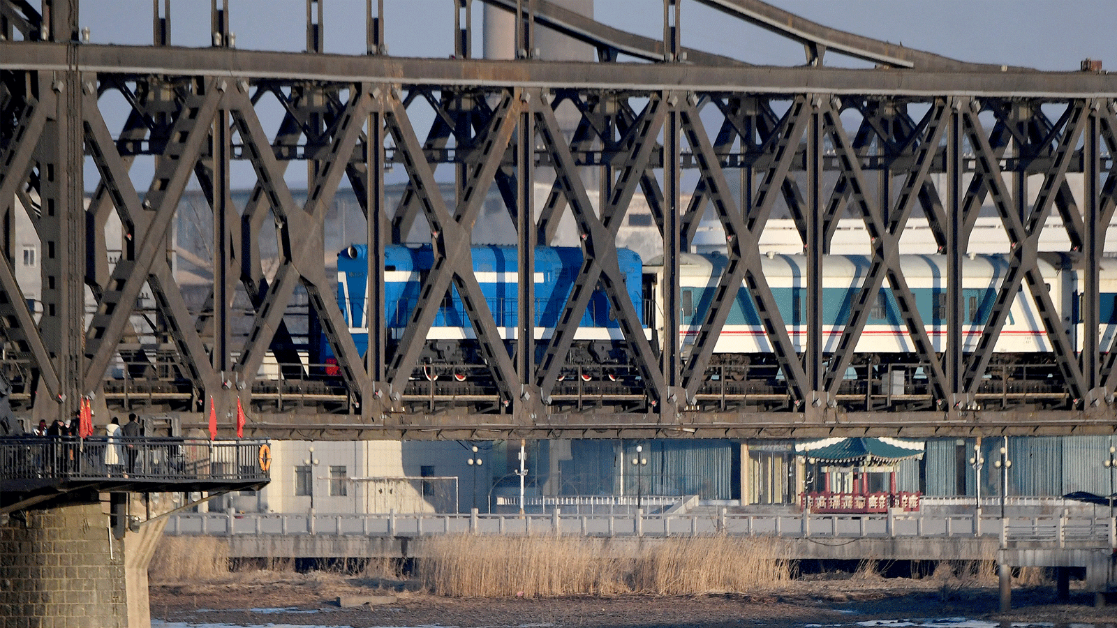  قطار ركاب مجدول يعبر جسر الصداقة الصينية الكورية من كوريا الشمالية إلى مدينة داندونغ الصينية الحدودية في مقاطعة لياونينغ شمال شرق الصين في 23 شباط\فبراير 2019.