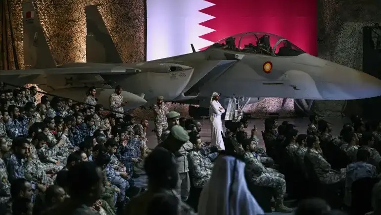 جنود وموظفون أميركيون وقطريون ينتظرون الرئيس دونالد ترامب في قاعدة العديد الجوية جنوب غرب الدوحة، قطر، في 15 أيار (مايو) 2025