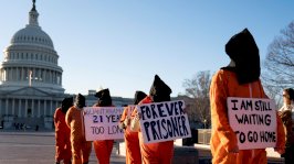 مجموعة من الأشخاص يرتدون زي السجناء يحتجون على معسكر الاعتقال في غوانتانامو خارج مبنى الكابيتول الأميركي في 9 كانون الثاني (يناير) 2023