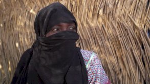 زينب تحمل ابنتها مريم بين ذراعيها - BBC