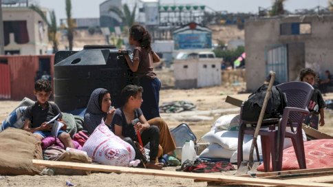 نازحون فلسطينيون يستريحون أثناء نصب خيمتهم بعد عودتهم إلى خان يونس في جنوب قطاع غزة